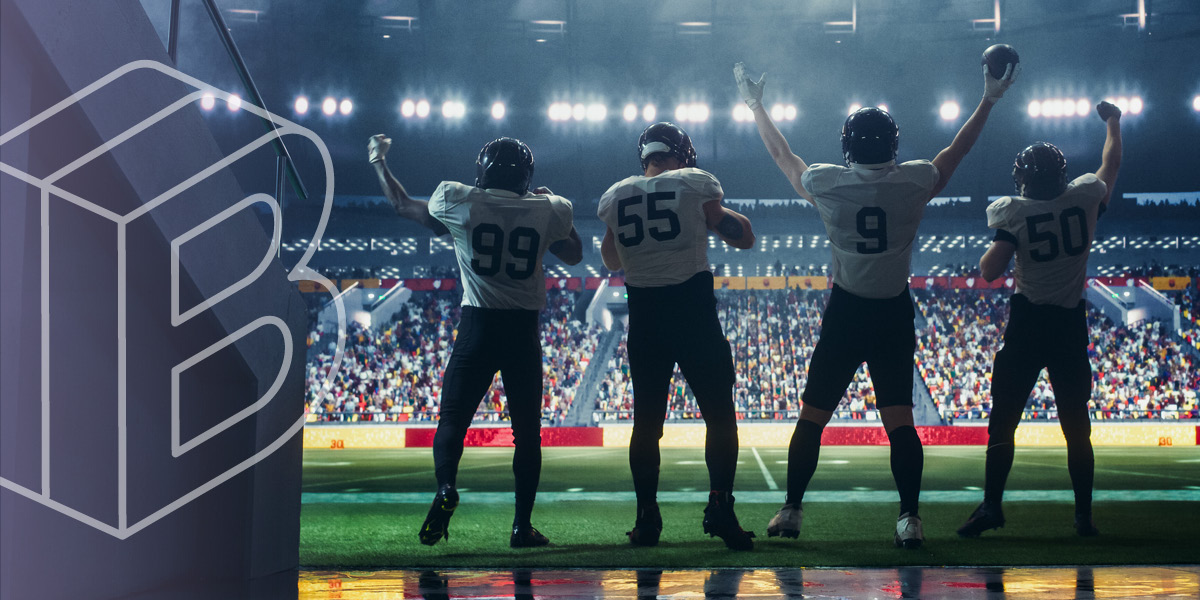 Banner Image: Football players standing on the edge of a field